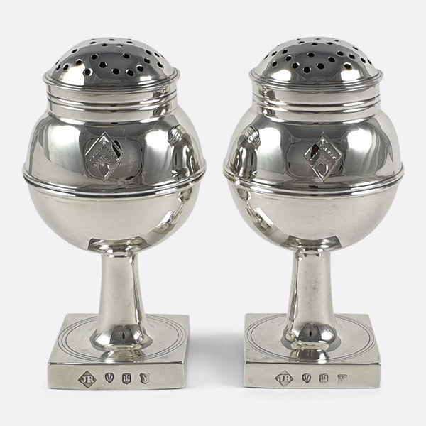 The pair of 1920s Scottish sterling silver pepper casters viewed from the front