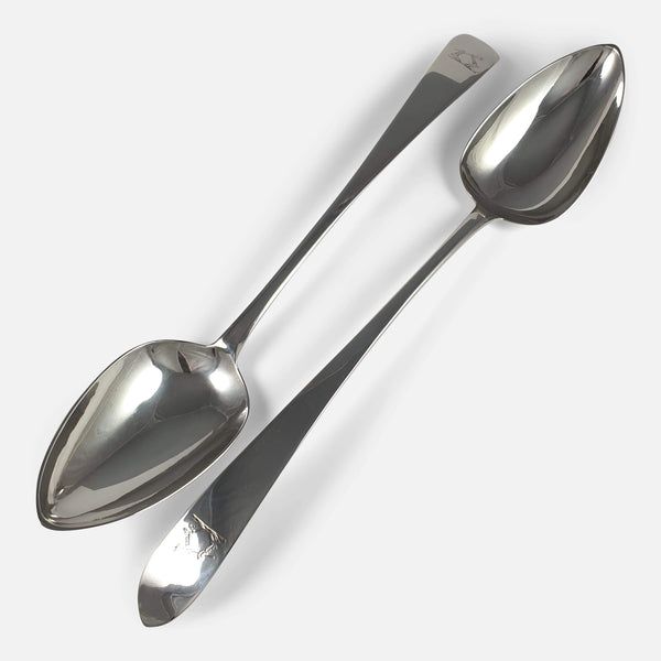 the pair of George III Irish silver basting spoons viewed diagonally