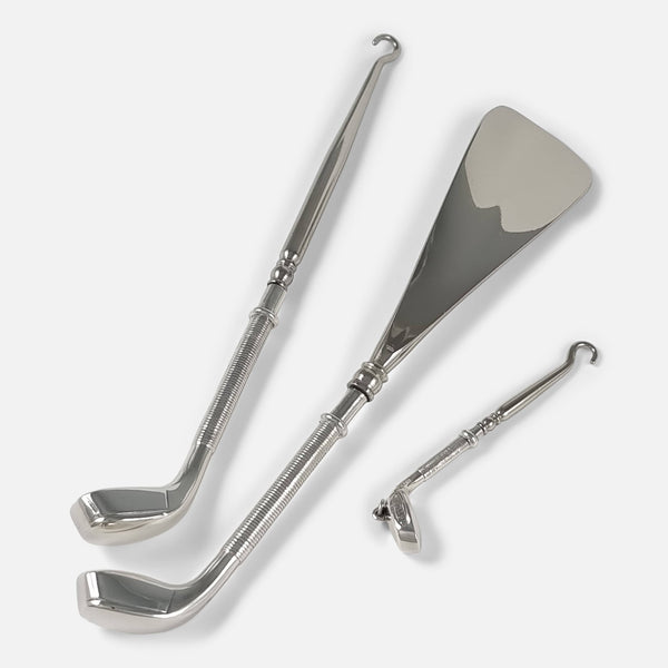 a novelty golfing interest sterling silver and steel shoe horn and button hook set viewed out of their case