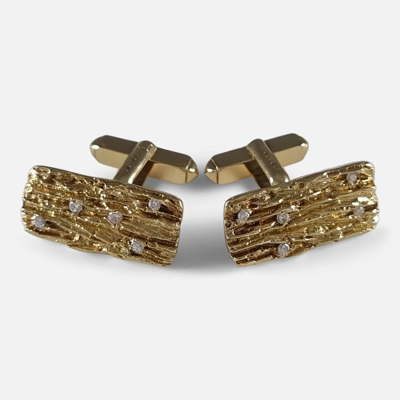 Viewed from above: cufflinks face forward but are slightly angled away from each other, revealing their unique design from an aerial perspective.