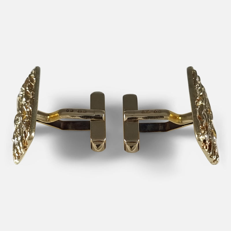 From above, cufflinks are positioned with their plaque fronts in opposing directions, swivel T-bar connectors locked in place, highlighting their wearability and design contrast.