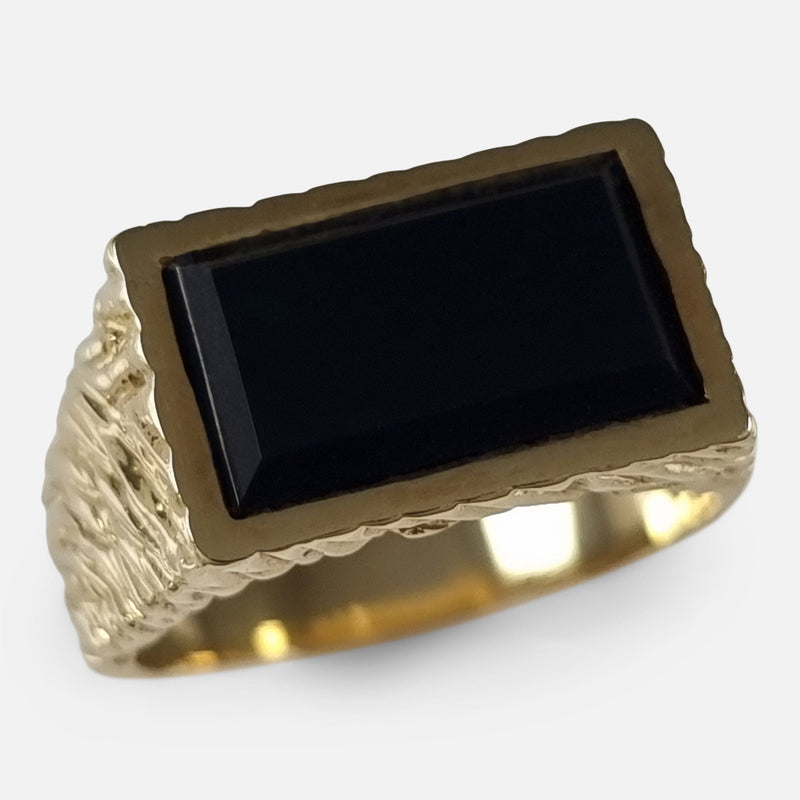 The 18ct Yellow Gold Onyx Signet Ring by Kutchinsky, viewed from above at a slight angle