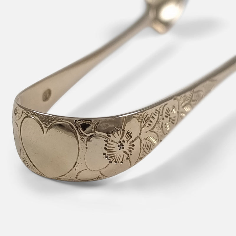 the heart shaped cartouche to the tongs