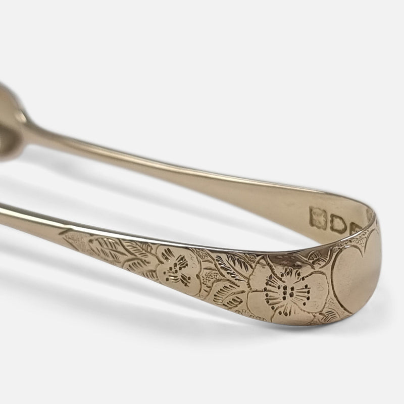 focused on the engraved decoration to the tongs