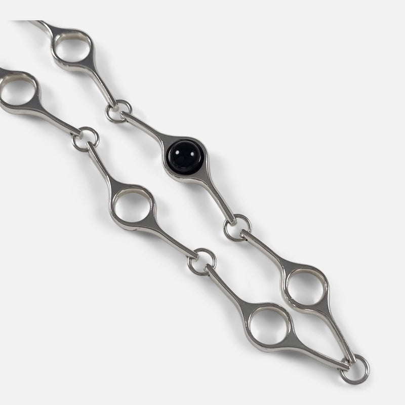 a section of the necklace in focus to include the onyx sphere