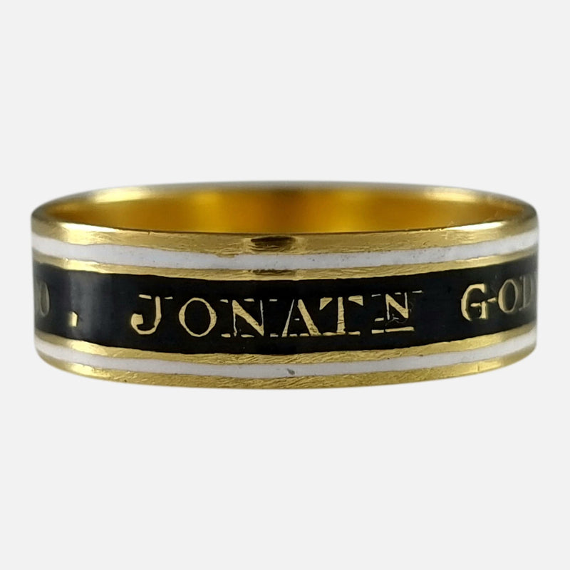 The George III 22ct Gold and Enamel Mourning Ring, with a section of the inscription in focus