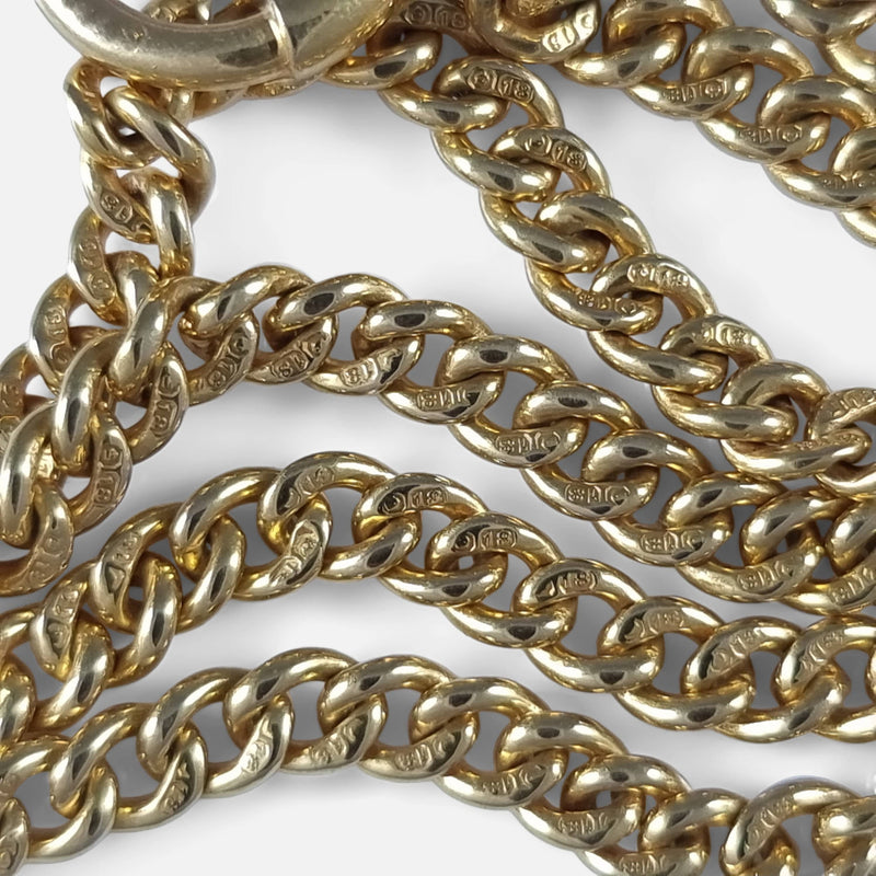 a number of chain links in focus with partial hallmarks