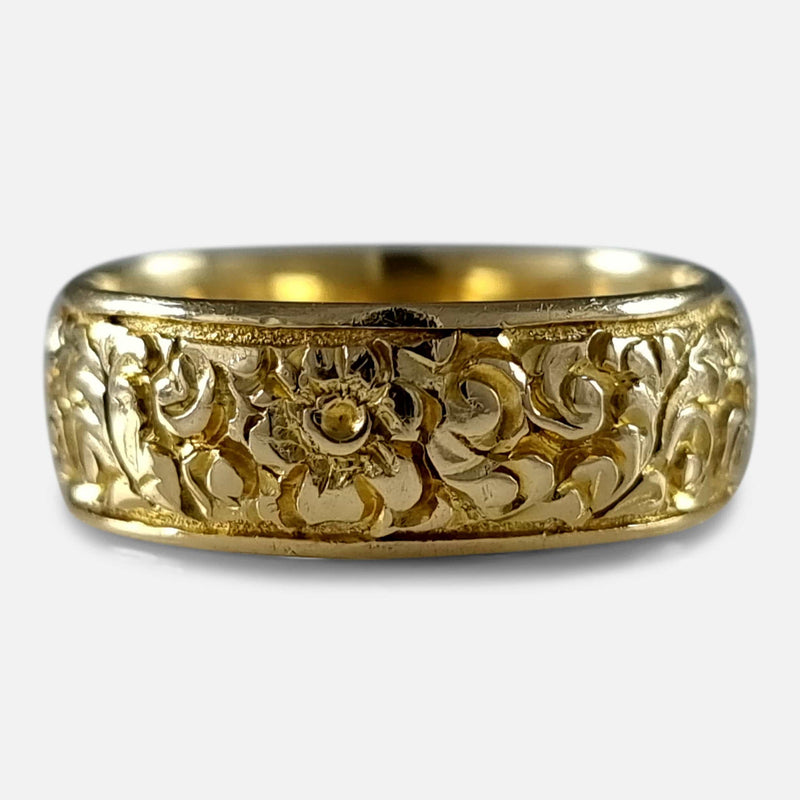 The George V 18ct yellow gold foliate engraved Keeper ring viewed from the front