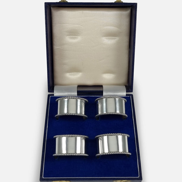 The Set of Four Sterling Silver Napkin Rings viewed in their case