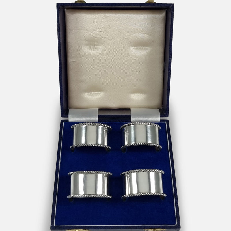 The Set of Four Sterling Silver Napkin Rings viewed in their case