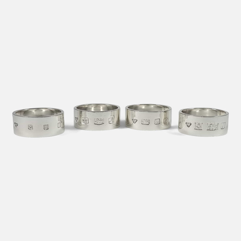 the four napkin rings viewed side by side with hallmarks to the forefront