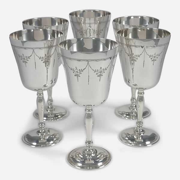 "Front view of six goblets in a diamond layout, emphasizing symmetry and elegance."
