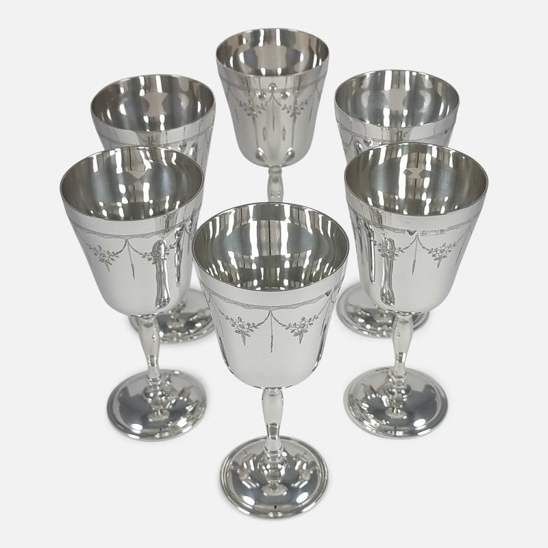 Near-overhead perspective of six goblets, detailing their layout and craftsmanship from an elevated angle.