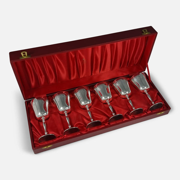Six Garrard & Co sterling silver goblets in their case, displayed at an angle to showcase craftsmanship