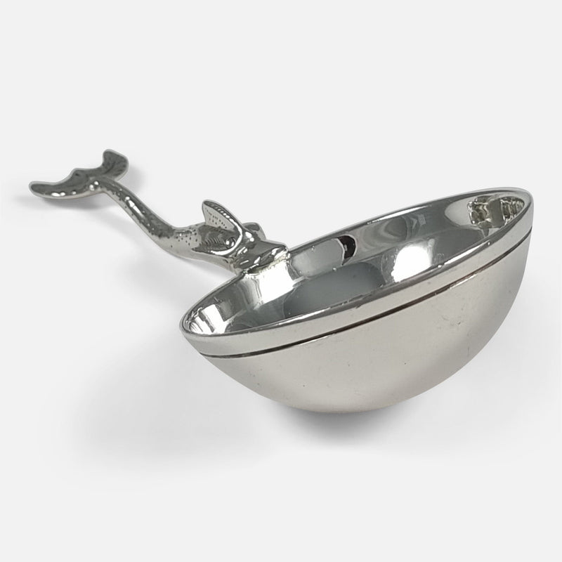 the ladle with bowl to forefront and pointing approximately towards the bottom right hand corner of the image
