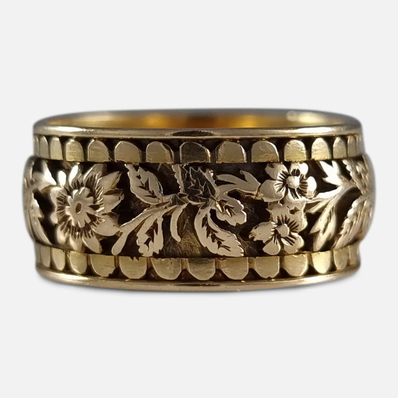 focused on a section of the foliate engraved decoration to the exterior of the ring