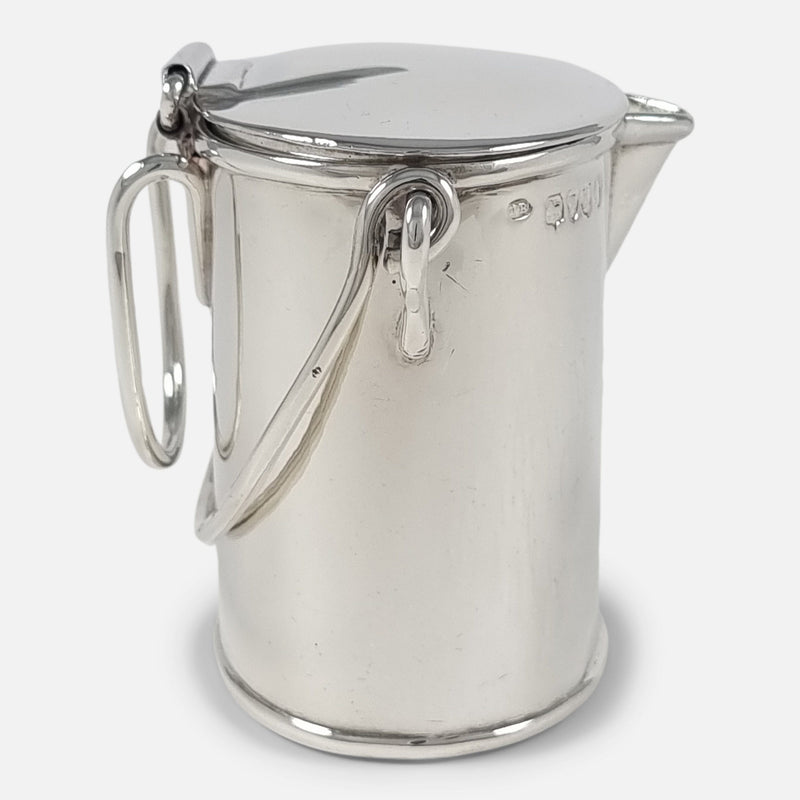 the cream pail side on with spout facing towards the right
