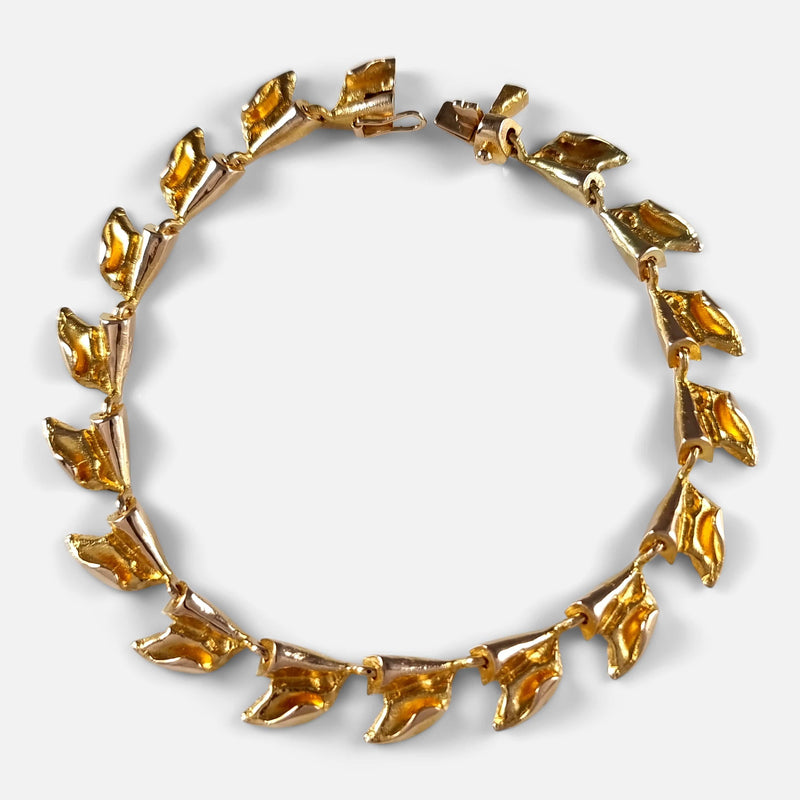 a birds eye view of the gold bracelet with clasp unfastened