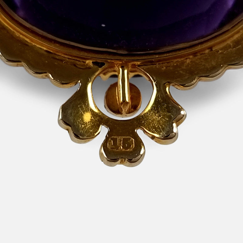 the marks to the back of the pendant