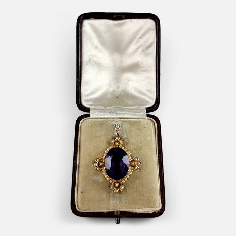 the gold pendant in its case
