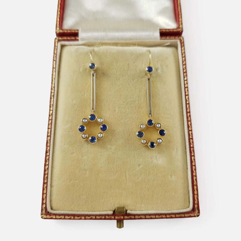 the sapphire and pearl earrings in their case