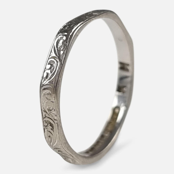 the 18 carat white gold foliate engraved ring  standing vertically and viewed at an angle