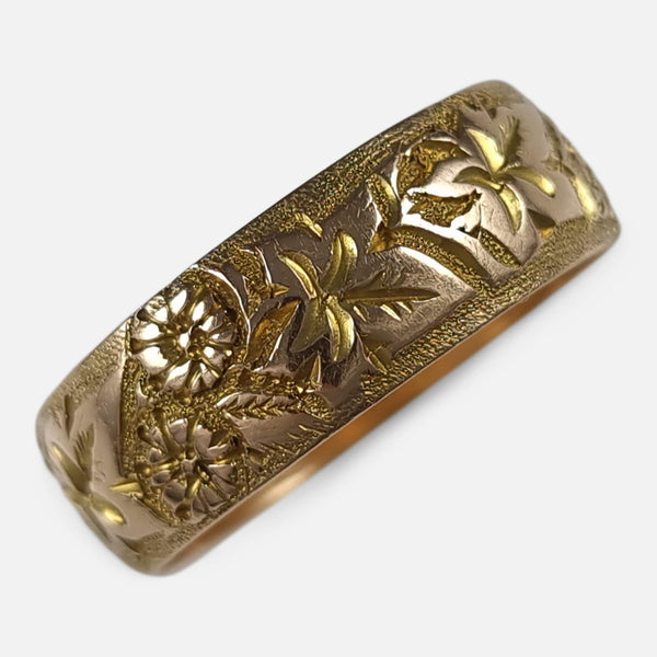 the antique 18ct yellow gold foliate engraved Keeper ring viewed diagonally from above