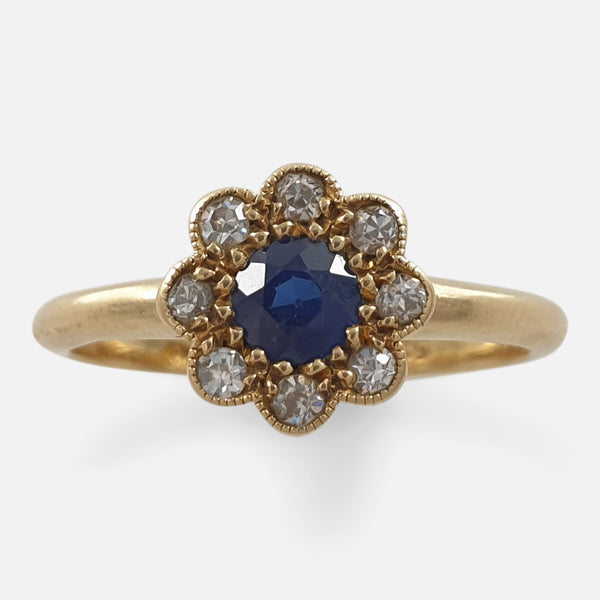 The Edwardian 18ct yellow gold sapphire and diamond daisy ring viewed face on from above