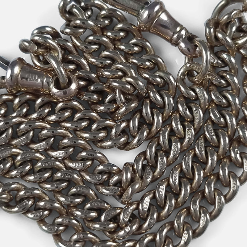 focused on a number of chain links with their gold hallmarks