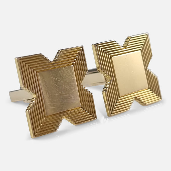 the pair of 9ct gold cufflinks by Garrard & Co, viewed at an angle