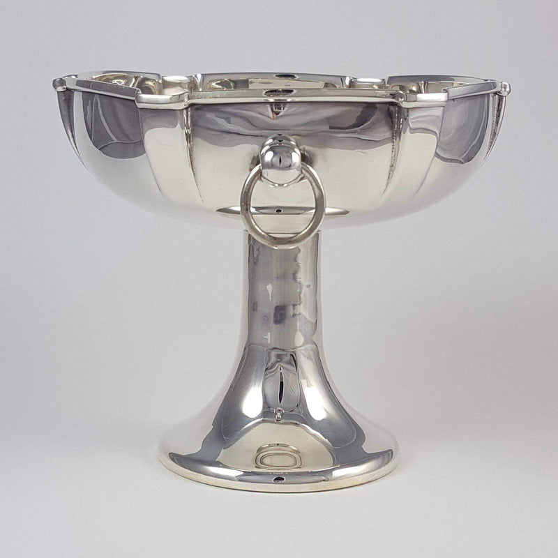 a side on view of the bowl with ring handle to forefront