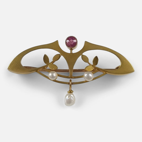 An Art Nouveau 9 carat gold tourmaline and pearl brooch viewed from the front