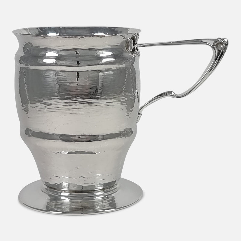 the Art Nouveau Sterling Silver Mug by Mappin & Webb viewed side on with handle pointing towards the right side