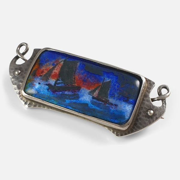 the Arts and Crafts silver and enamel brooch viewed at an angle