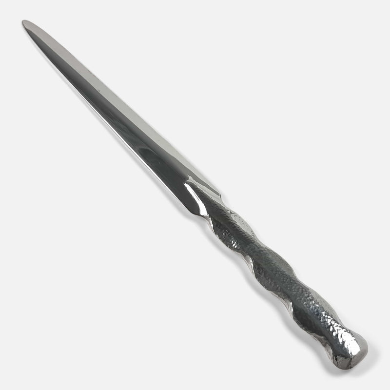 the silver letter opener viewed diagonally with blade pointing away