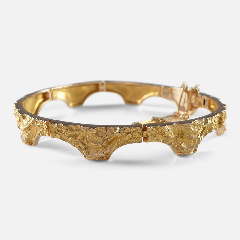 the gold bracelet viewed from the right at a slight angle