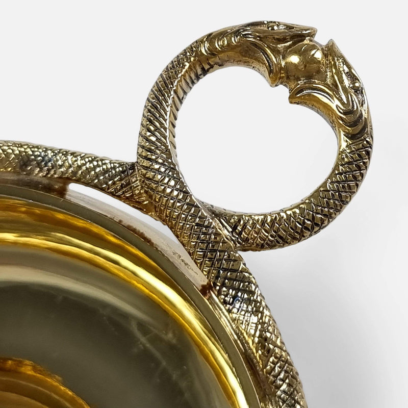 focused on the snake head handle of one of the cups