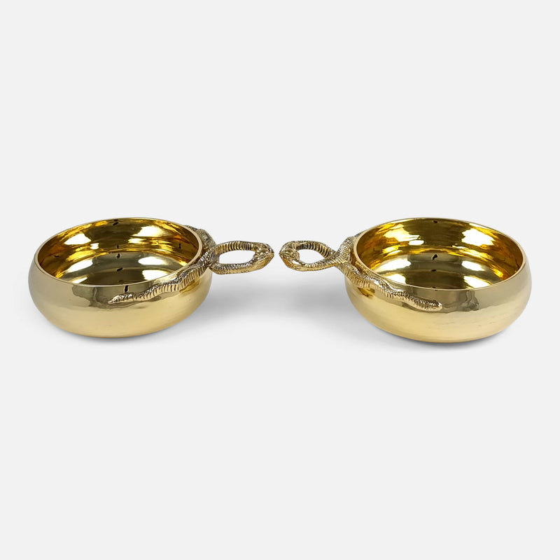 a side on view of the pair of cups with handles pointing towards each other