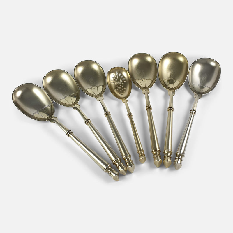 the silver fruit serving spoons spread out in a fan shape at a slight angle