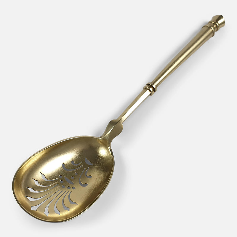 the sugar sifting spoon viewed diagonally with bowl to forefront