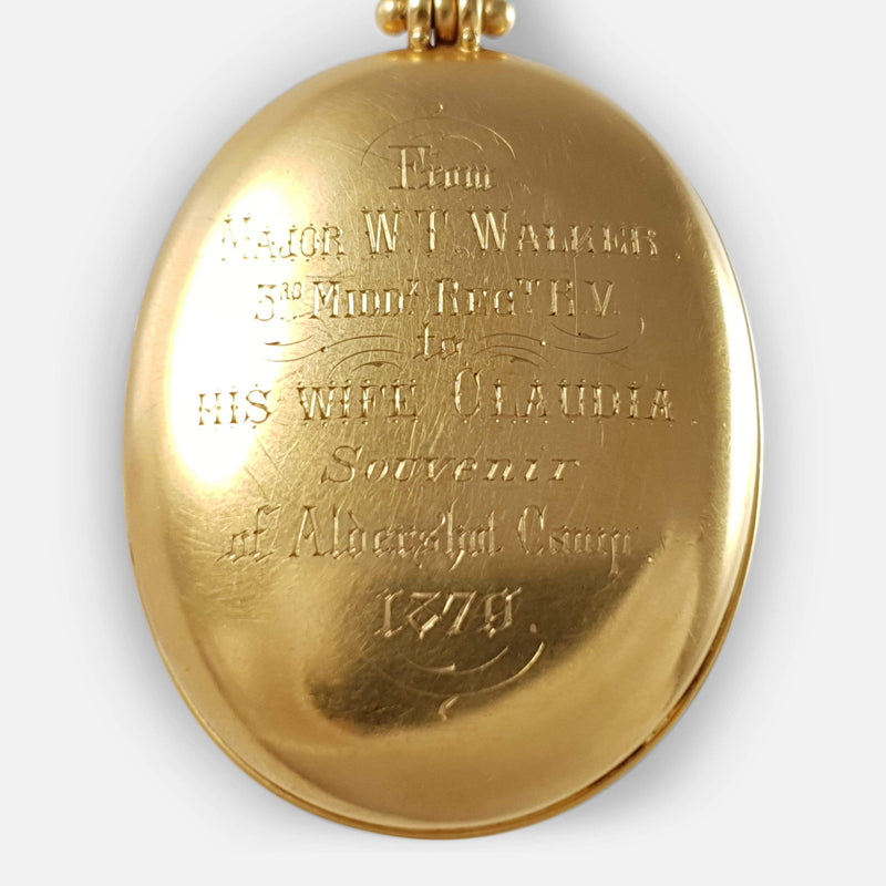 focused on the engraved inscription to the back of the locket