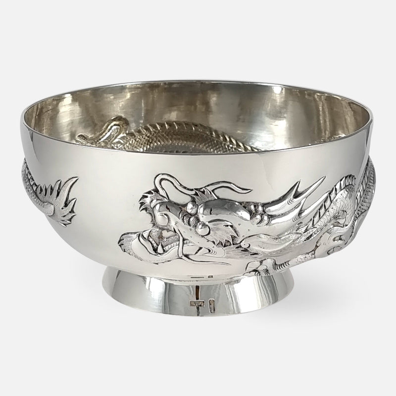 the antique Chinese export silver dragon bowl by Wang Hing, with head in focus