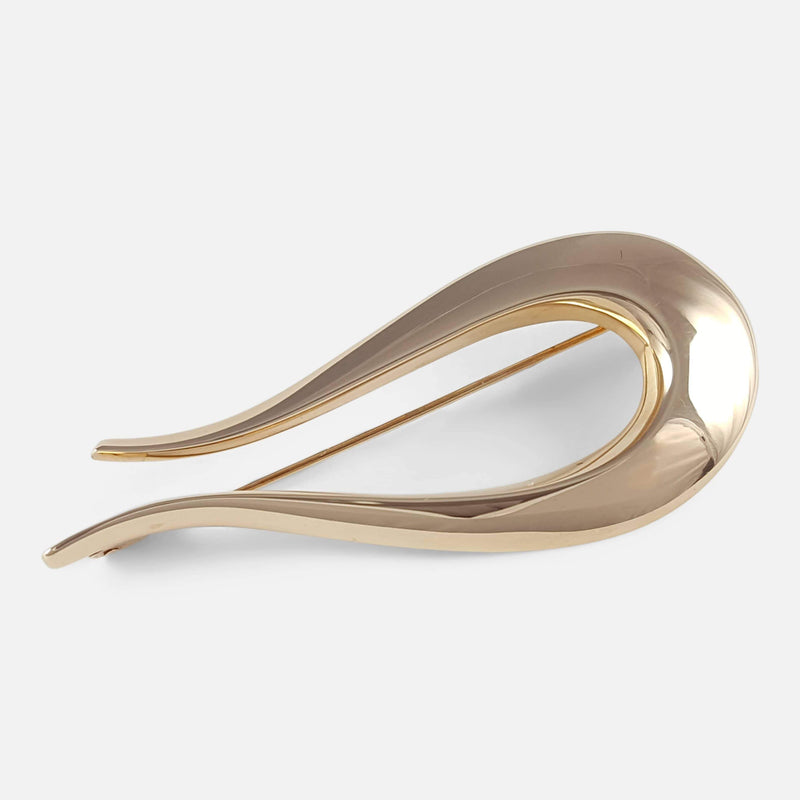 the yellow gold brooch viewed diagonally