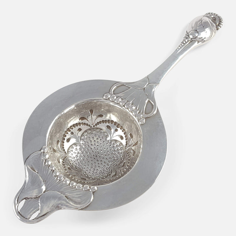 the strainer viewed diagonally with pierced bowl to the forefront