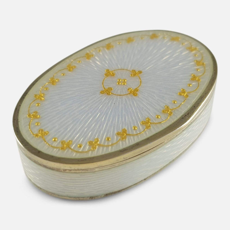 the silver gilt and enamel pill box viewed from a raised position diagonally