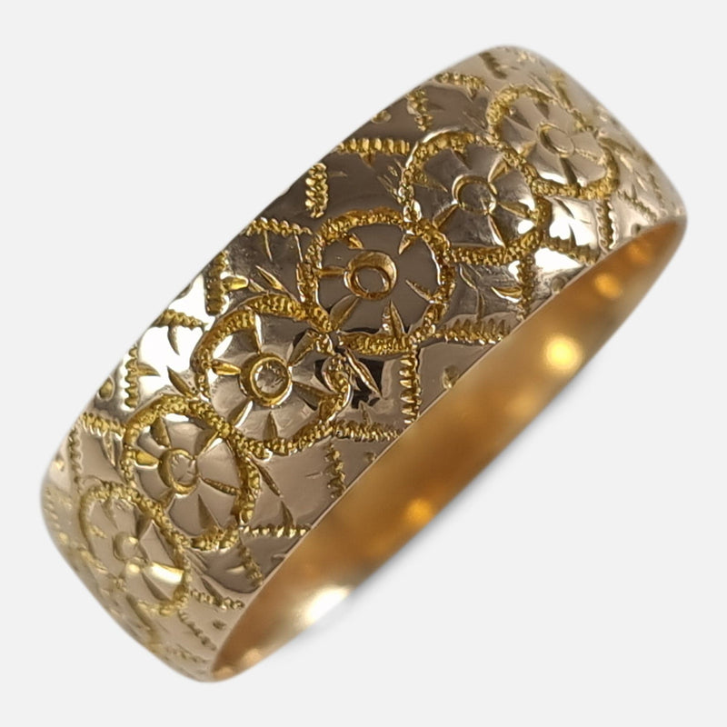 the Edwardian 18ct yellow gold engraved keeper ring viewed diagonally