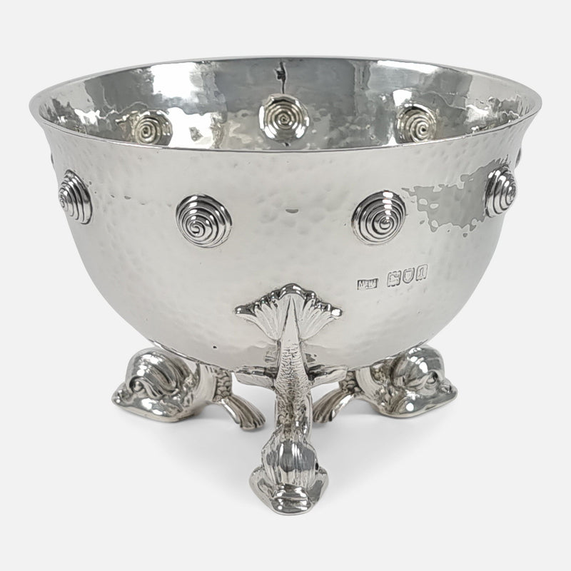 the bowl rotated to have one of the dolphin feet to the forefront