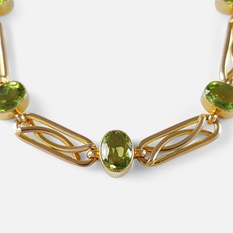 focused on a section of the peridot and gold bracelet