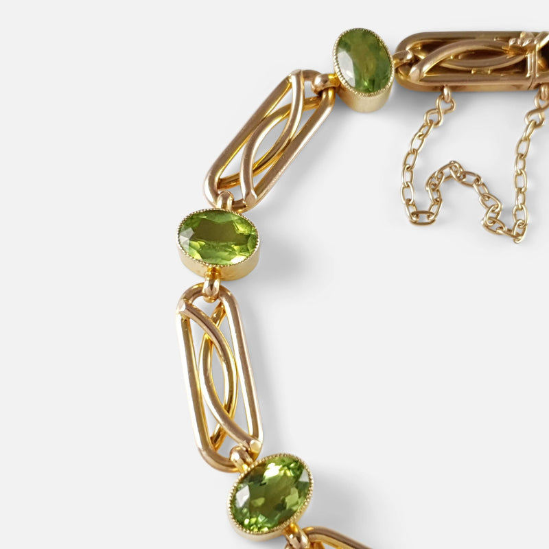 focused on a section of the peridot and gold bracelet