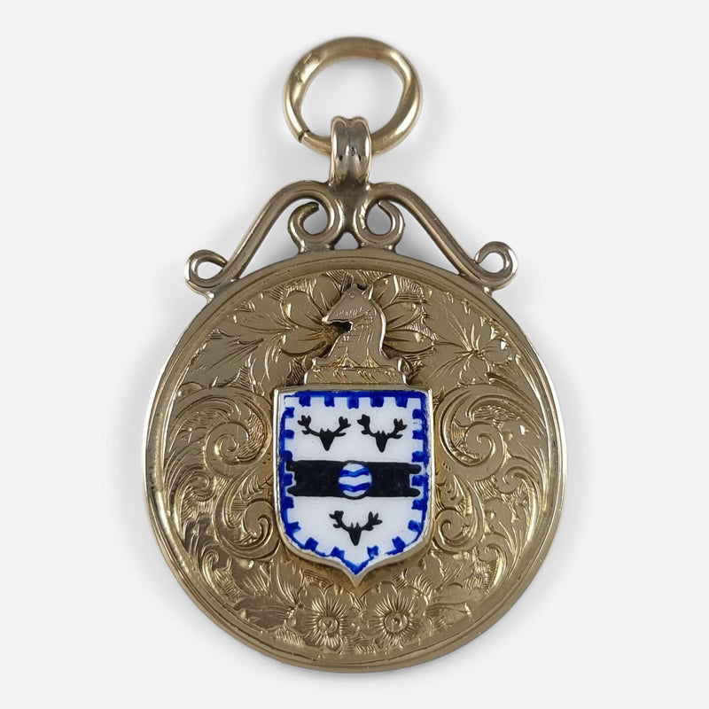 a birds eye view of the gold and enamel pendant